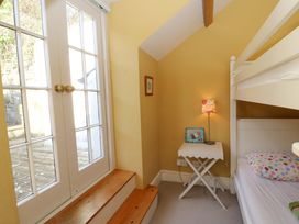 A bedroom with a bunk bed and a table in Zenobia New Quay