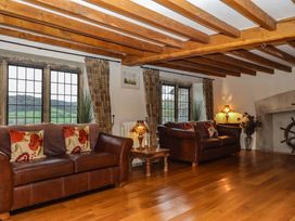 A living room with couches and lamps at Higher Wadden Farm in Southleigh