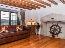 A living room with a sofa and a fireplace at Higher Wadden Farm in Southleigh