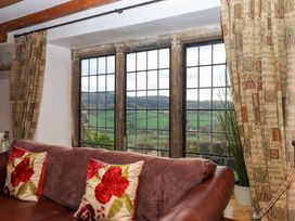 A living room with a window and sofa at Higher Wadden Farm in Southleigh