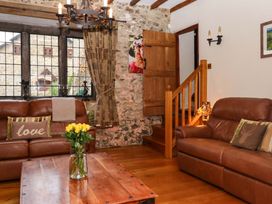 A living room with a sofa and coffee table at Higher Wadden Farm in Southleigh