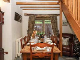 A dining room with a table and chairs at Higher Wadden Farm in Southleigh