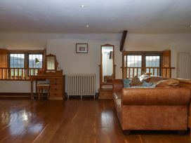 A living room with a sofa and table at Higher Wadden Farm Southleigh
