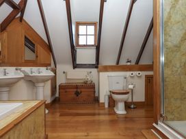 A bathroom with sinks, a toilet and a shower at Higher Wadden Farm in Southleigh