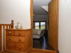 A hallway leading to a bedroom at Higher Wadden Farm in Southleigh