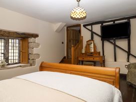 A bedroom with a bed and window at Higher Wadden Farm Southleigh