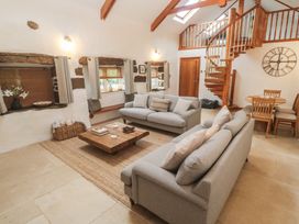A living room with sofas and a coffee table at Riverside Barn Stithians