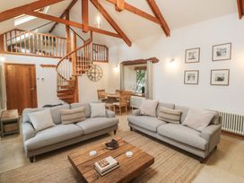A living room with sofas and a coffee table at Riverside Barn in Stithians