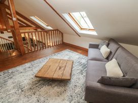 A living room with a sofa and coffee table at Riverside Barn Stithians