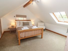A bedroom with a bed and skylight at Riverside Barn Stithians