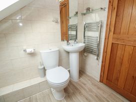 A bathroom with a toilet and sink at Riverside Barn Stithians
