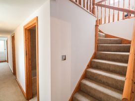 A hallway with stairs and doors at Riverside Barn in Stithians