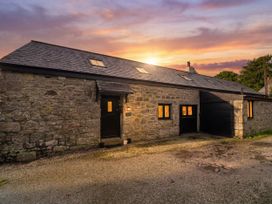 An exterior view of a barn with windows and a door at Riverside Barn in Stithians