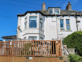 An exterior view of a house with a deck and garden at Ferncliffe
