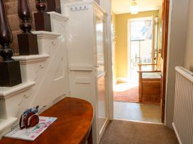 A hallway with a staircase and table at Ferncliffe