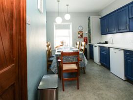 A kitchen with a dining table and chairs at Ferncliffe
