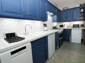 A kitchen with countertop, sink, oven and refrigerator at Ferncliffe