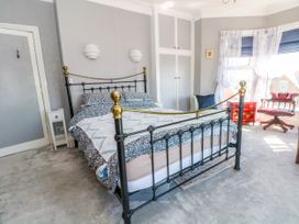 A bedroom with a bed and furniture at Ferncliffe 