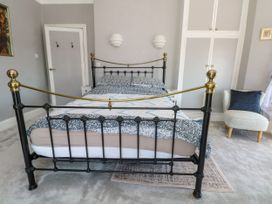 A bedroom with a bed and wardrobe at Ferncliffe