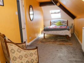 A bedroom with a bed and a chair at Ferncliffe in 