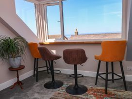A breakfast nook with bar stools and a window view at Ferncliffe 