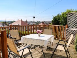 An outdoor patio with a table and chairs at Ferncliffe