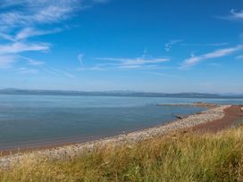 A view of the sea and shoreline with a path at Ferncliffe