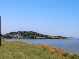 A view of an island with trees and houses near the shoreline at Ferncliffe in 