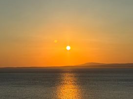 A sunset over the ocean with sun and horizon at Ferncliffe in Morecambe