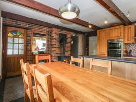 A kitchen with a dining table and chairs at Neuadd Wen in Gaerwen