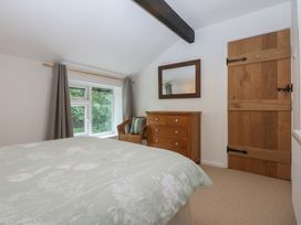 A bedroom with a bed and dressing table at Neuadd Wen in Gaerwen