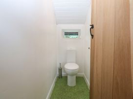 A bathroom featuring a toilet and sink at Neuadd Wen in Gaerwen