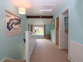 A hallway with a map on the wall and a table at Neuadd Wen Gaerwen