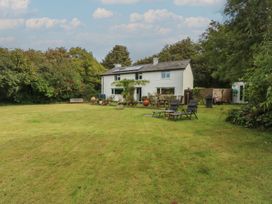 A house with a garden and chairs at Neuadd Wen in Gaerwen