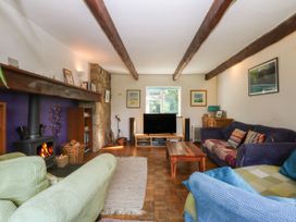 A living room with a television and fireplace at Neuadd Wen in Gaerwen