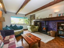 A living room with a sofa and armchair at Neuadd Wen in Gaerwen
