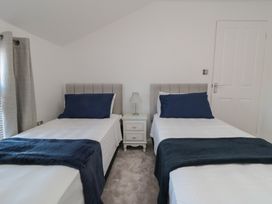 A bedroom with two single beds and a bedside table at 23 South Lackenby in Eston
