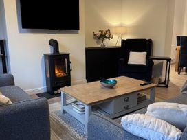 A living room with a coffee table and television at Ironstone Cottage in Eston