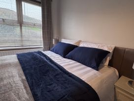A bedroom with a bed and pillows at Ironstone Cottage in Eston
