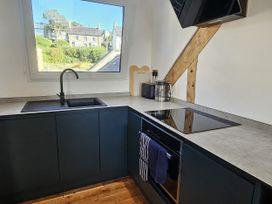 A kitchen with a sink and cooktop at Awel Deg in Cardigan
