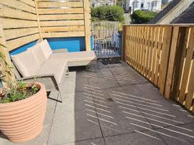 An outdoor area with a sofa and flower pot at Awel Deg in Cardigan