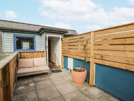 An outdoor area with a sofa and a plant pot at Awel Deg, Tresaith