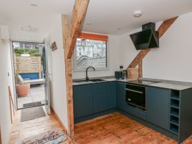 A kitchen with a sink and oven at Awel Deg, Tresaith