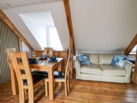 A dining area with a table and chairs at Awel Deg, Tresaith