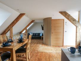 A dining room with a table and chairs at Awel Deg, Tresaith