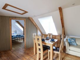 A dining room with a table and chairs at Awel Deg, Tresaith