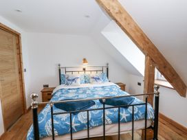 A bedroom with a bed and bedside tables at Awel Deg, Tresaith