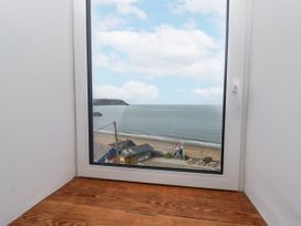 A view of the ocean and beach from a window at Awel Deg, Tresaith