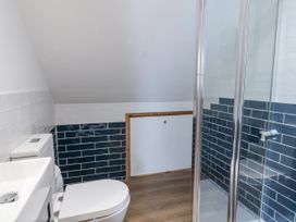 A bathroom with a shower and toilet at Awel Deg, Tresaith