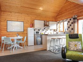 A kitchen with a dining table and appliances at Trevano St Breward